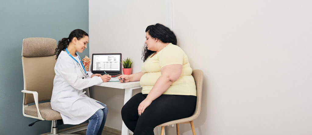 Woman visits nutritionist for treatment obesity in weight loss clinic