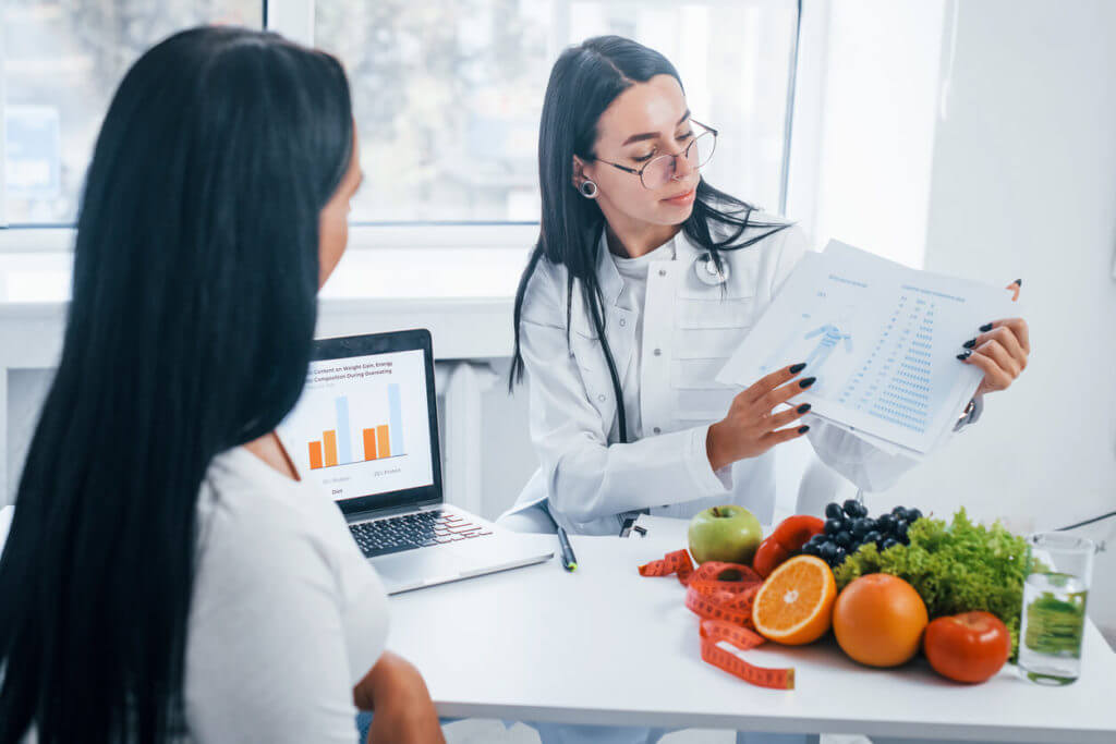 Female nutritionist suggesting Best Dietary Supplements for Weight to patient